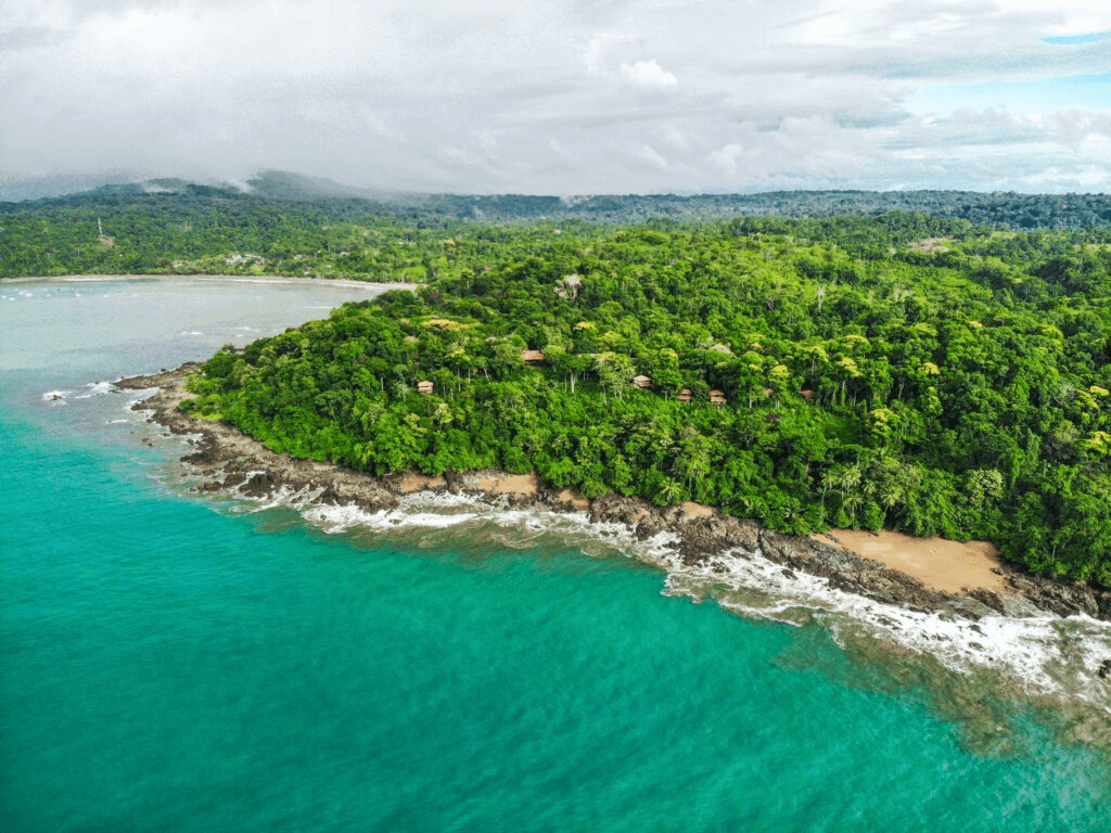 cliffs, a beach, jungle and houses inbetween